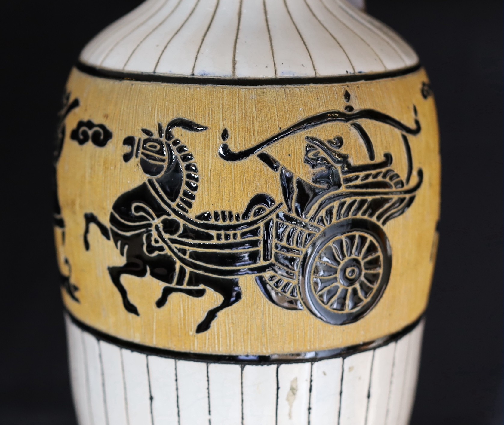 A 20th century Continental tinglazed pottery table lamp, decorated within a band of horse riders and birds, height without shade 62cm